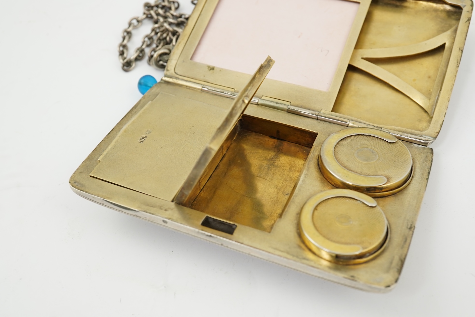 An early 20th century continental 800 standard silver combination, card, coin, aide memoir and pill case, with pencil and ribbed decoration, maker WK